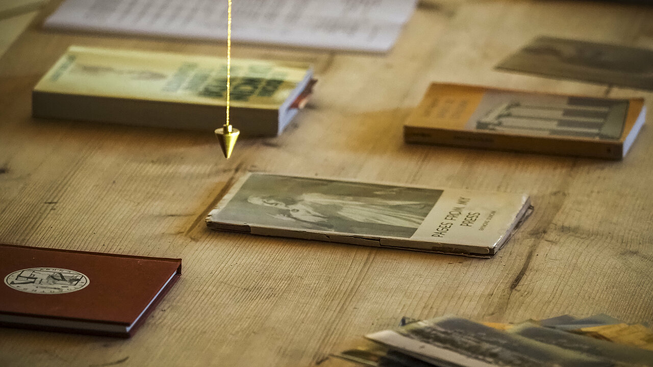 some books and a pendulum